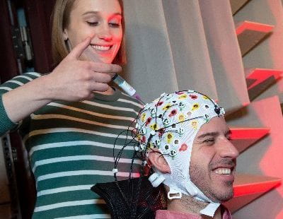 http://Research%20applies%20gel%20to%20electrodes%20in%20an%20EEG%20cap%20on%20a%20participant